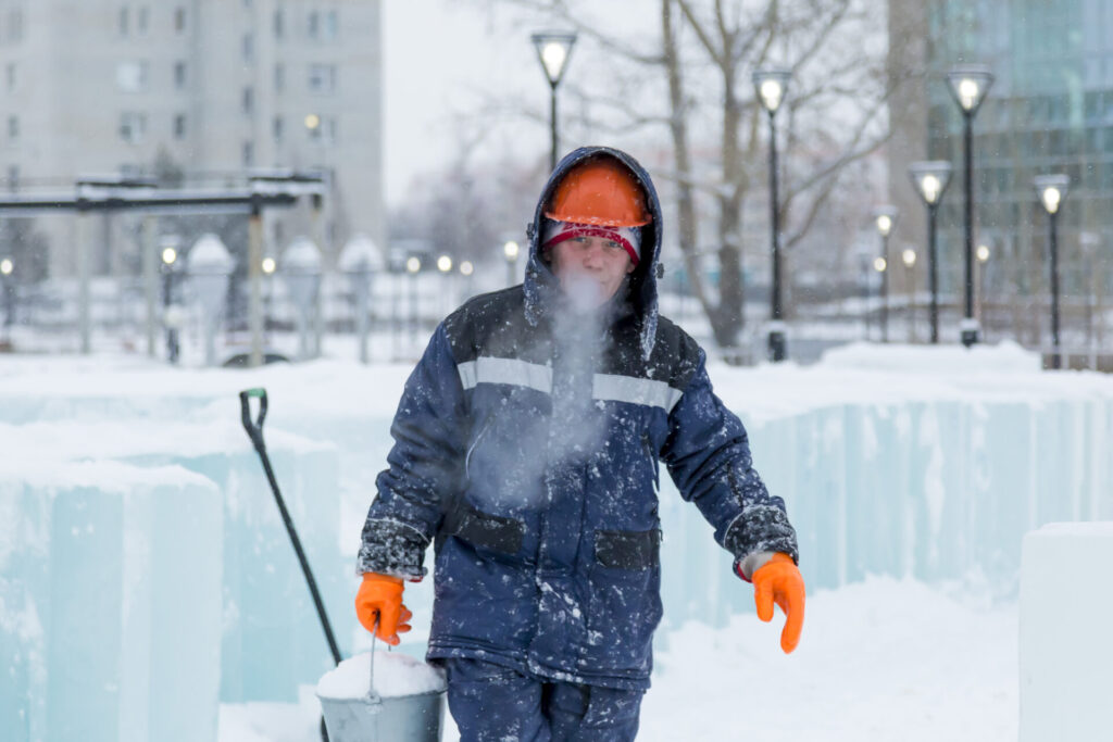 Portrait of an assembler in an orange helmet